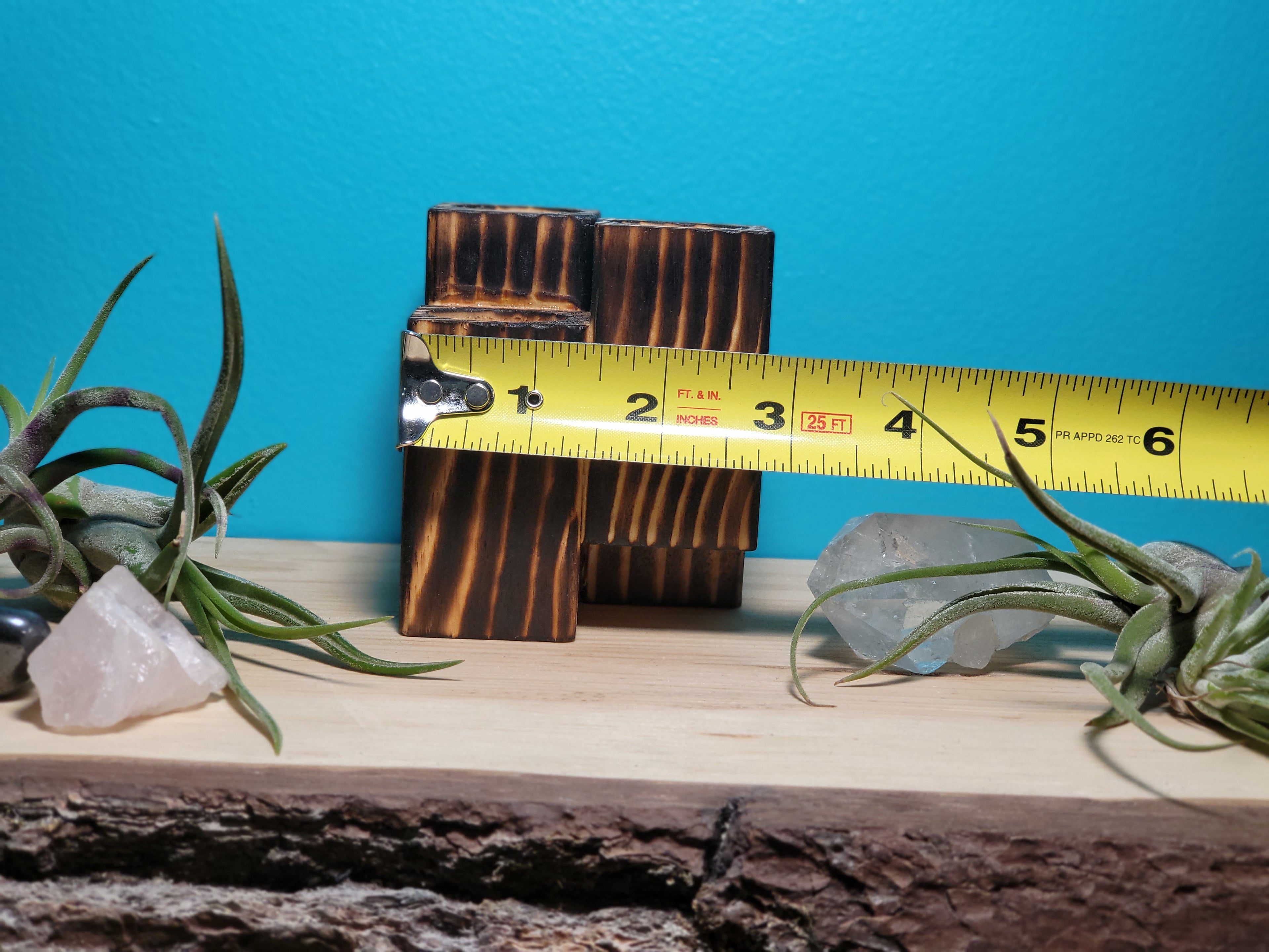 Air-Plant Wooden block with a measuring tape on a wooden surface against a blue wall